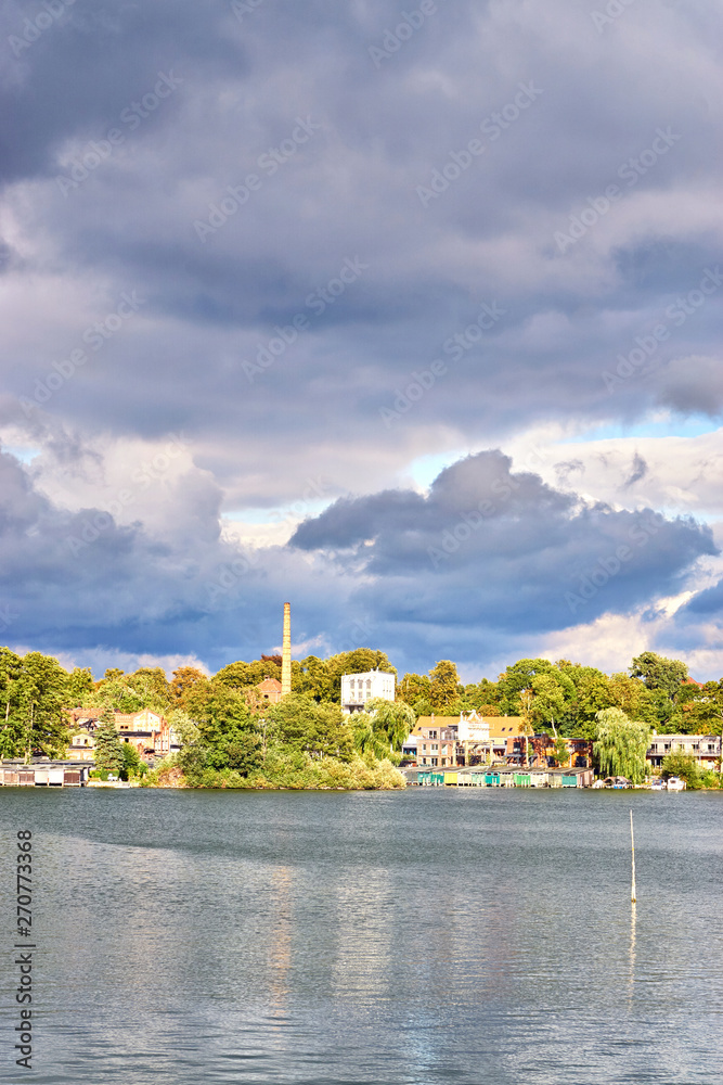 Old residential area at the Ziegelsee in Schwerin under dramatic clouds. Mecklenburg-Vorpommern, Germany