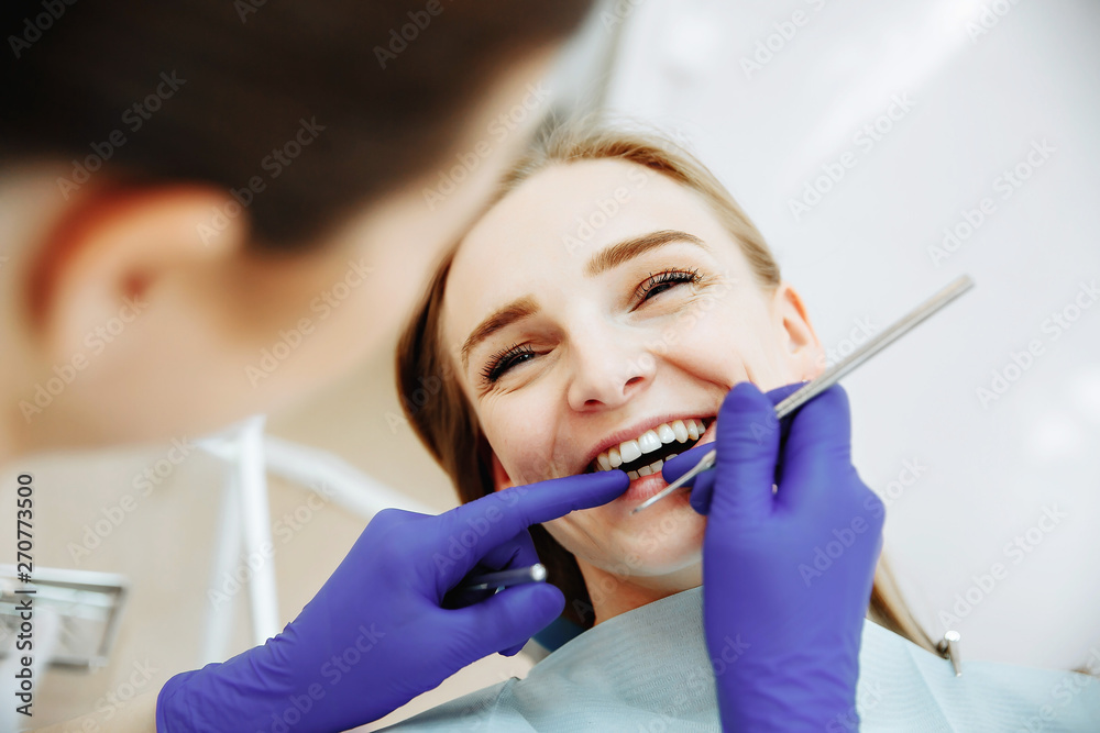 Woman at the dentist smiling. Work of stomatologist with patient. Woman at the dentist smiling. Work of stomatologist with patient.