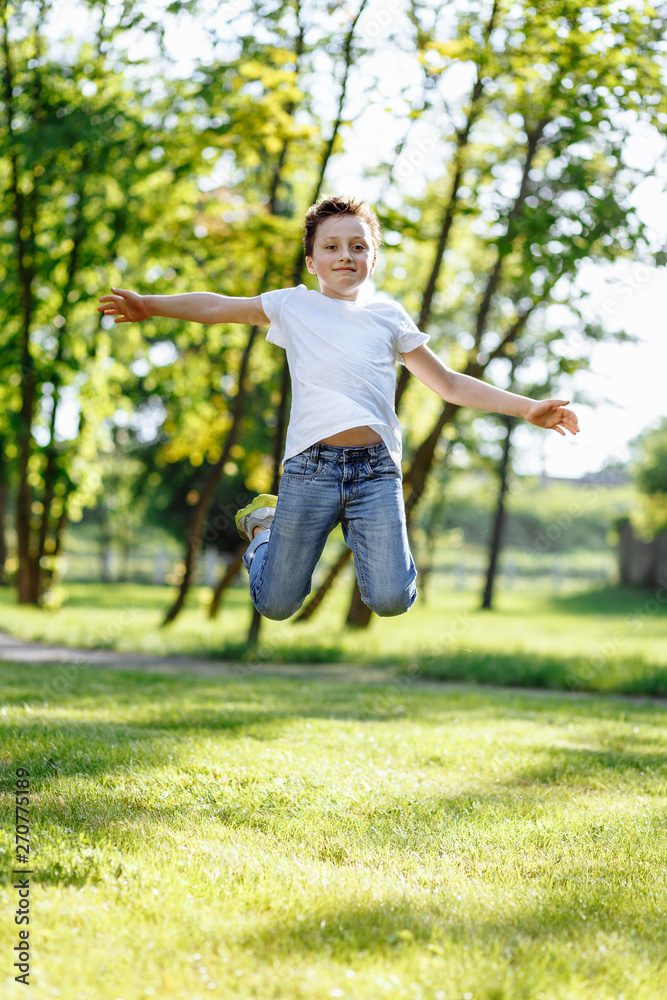 Little boy jumping outdoors. Have fun on the grass in the simmer park. Little boy jumping outdoors. Have fun on the grass in the simmer park.