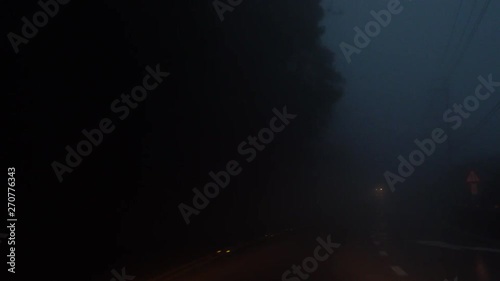 Driving Car in Dense Fog in the Evening. Bad Weather Condition with Zero Visability. Perspective View from Cabin photo
