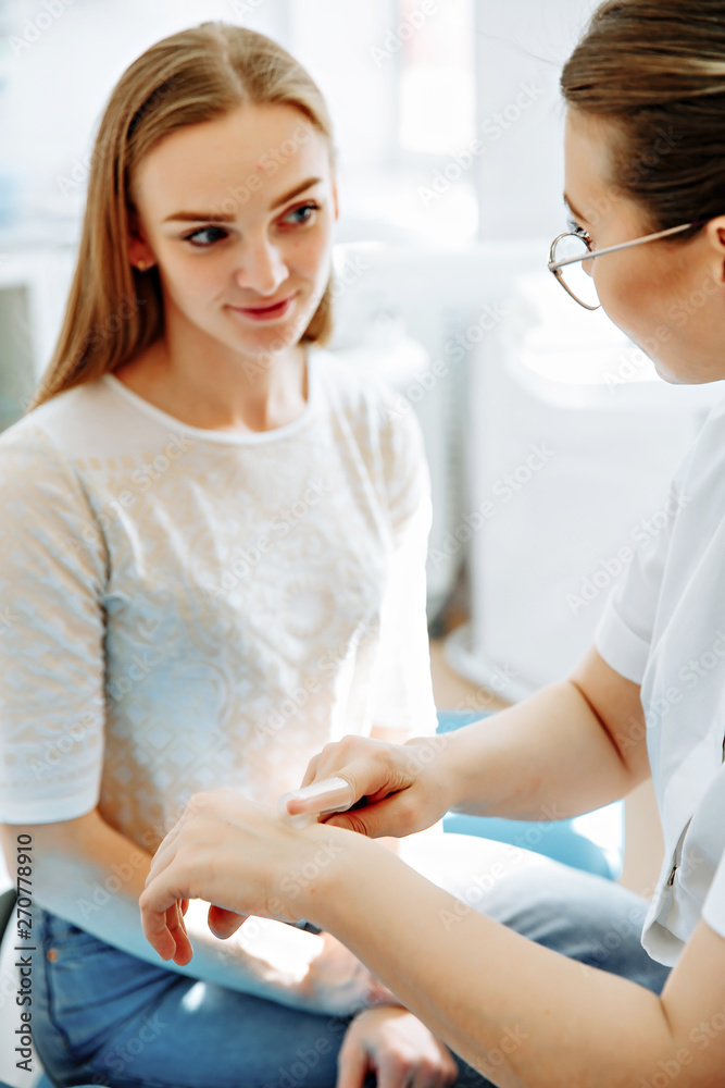 Consultation with doctor. Portrait of beautiful woman sitting in dental chair while stomatologist holding toothbrush Consultation with doctor. Portrait of beautiful woman sitting in dental chair while stomatologist holding toothbrush