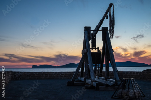 Dramatic sunset over the sea front in Alghero (L'Alguer), province of Sassari , Sardinia, Italy.