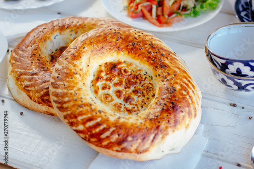Foto Asian naan or non - oriental bread on white.