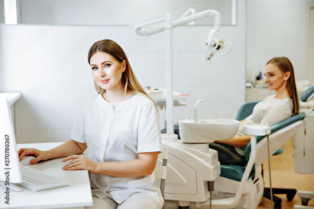 smart charming woman dentist sitting on computer desk with his hand read document, smile and looking at camera