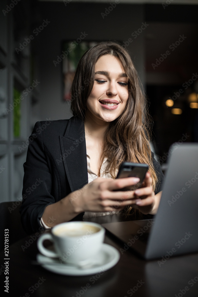 Charming woman with beautiful smile reading good news on mobile phone during rest in coffee shop. Caucasian female watching her photos on cell telephone while relaxing in cafe during free time Charming woman with beautiful smile reading good news on mobile phone during rest in coffee shop. Caucasian female watching her photos on cell telephone while relaxing in cafe during free time