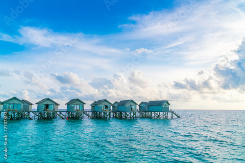 Fototapeta Naklejka Na Ścianę i Meble -  Beautiful water villas in tropical Maldives island at the sunset time .