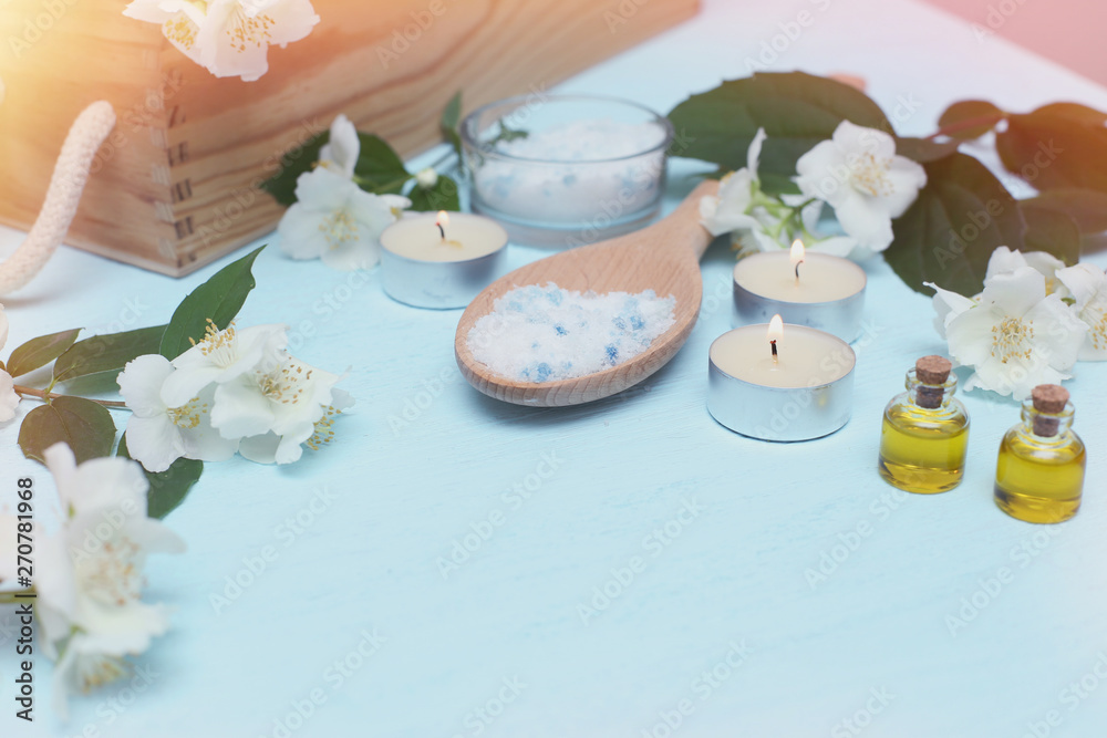 Aromatic oils, sea salt, candles and jasmine flowers. Spa ingredients for massage and relaxation.
