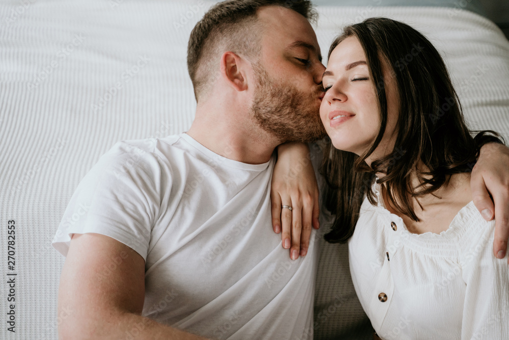 Couple in love in the bedroom. Slender brunette. Stylish interior. Couple in love in the bedroom. Slender brunette. Stylish interior.