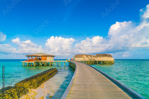 Fototapeta Naklejka Na Ścianę i Meble -  Beautiful water villas in tropical Maldives island at the sunrise time .