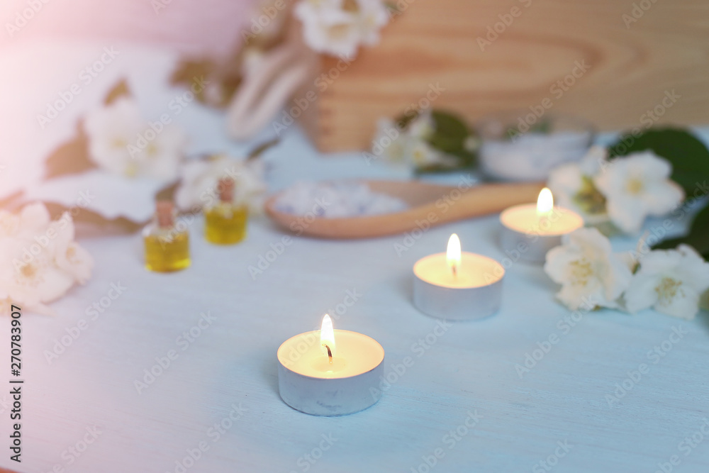 Aromatic oils, sea salt, candles and jasmine flowers. Spa ingredients for massage and relaxation.