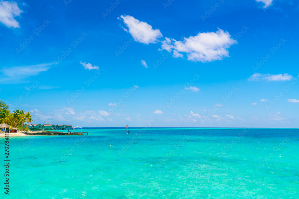 Beautiful tropical Maldives island with white sandy beach and sea .