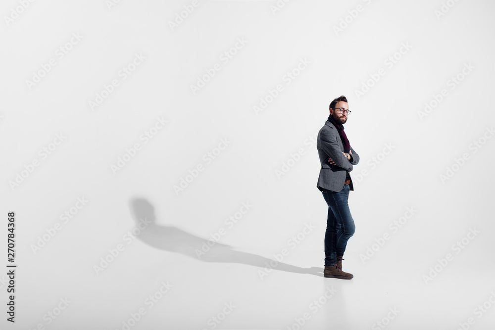 Stylish man isolated on white studio background, eyeglasses, standing full height, with crossed arms, looking at camera. Stylish man isolated on white studio background, eyeglasses, standing full height, with crossed arms, looking at camera.