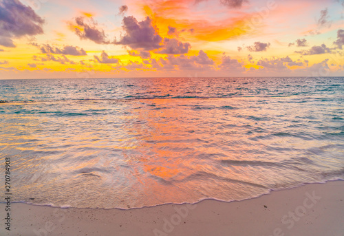 Beautiful sunset with sky over calm sea in tropical Maldives island .