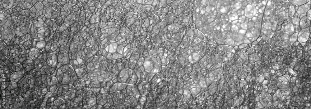 Black and white banner with a structural lattice of soap suds for washing dishes