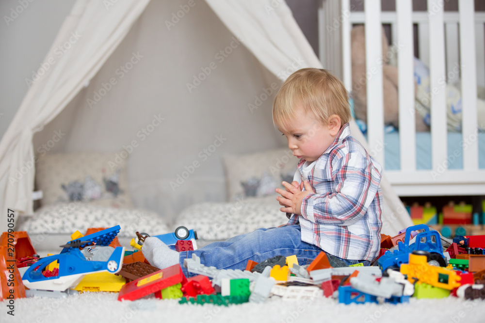Child toddler playing with construction toys at home Child toddler playing with construction toys at home