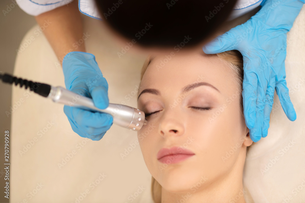 Top view of dermatologist doing under eye skin treatment Top view of dermatologist doing under eye skin treatment