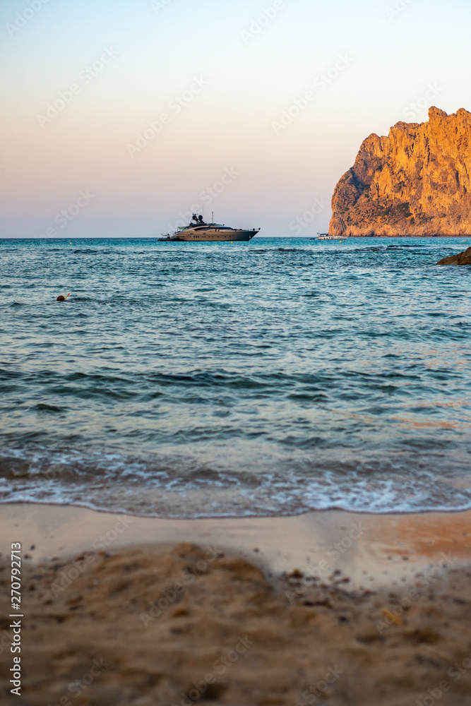 Luxury Yacht Anchored in Tranquil Bay in the Mediterranean Sea at Sunset