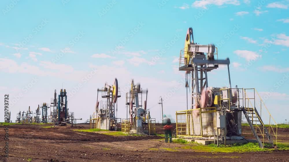 operating pump jacks on oil field under blue sky timelapse operating pump jacks on oil field under blue sky timelapse