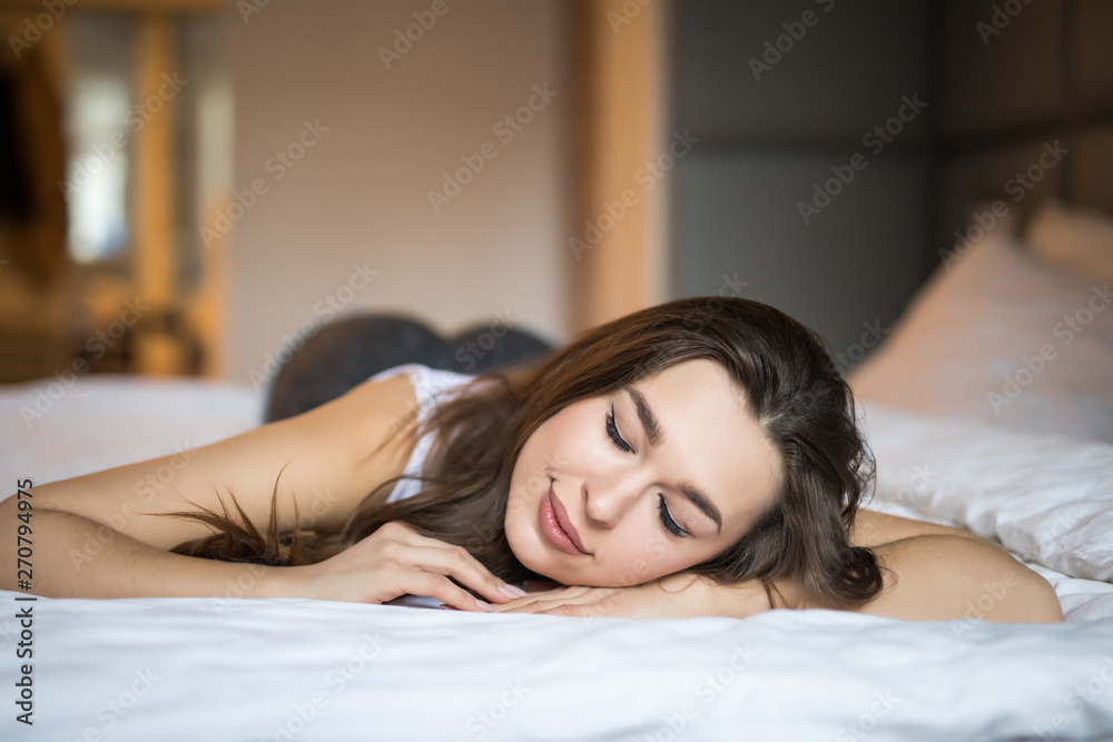 Beautiful young woman basking in bed in the morning. Beautiful young woman basking in bed in the morning.