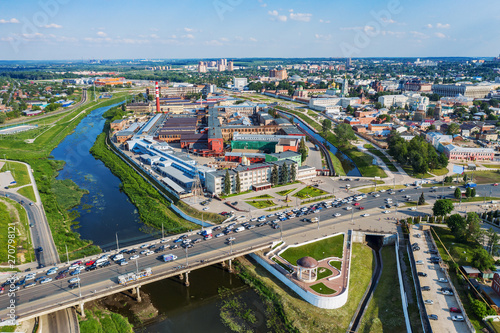 Aerial view of Tula city center or downtown with bridge over river Upa, modern and historic buildings, factories and car traffic