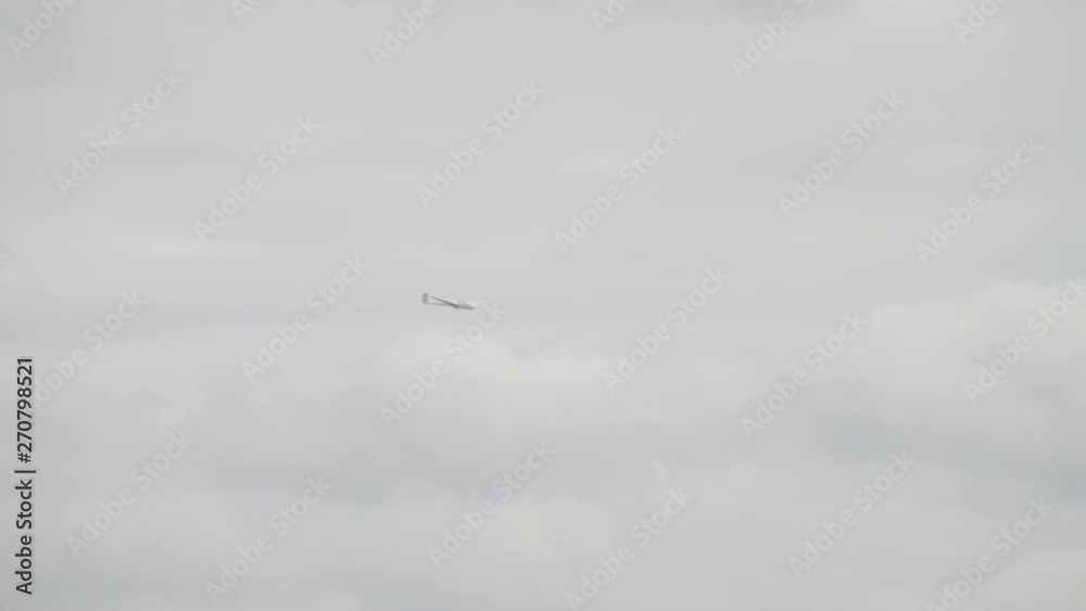 Glider sailplane flying through the sky - wide shot Glider sailplane flying through the sky - wide shot
