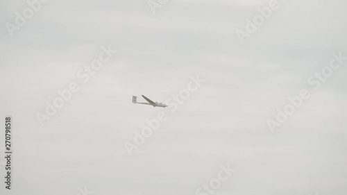 Glider sailplane flying through the sky - medium shot photo