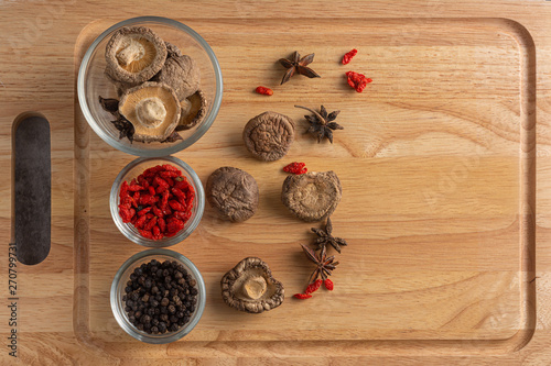 Various Oriental spices and herbs with mushroom in glass Bowl.