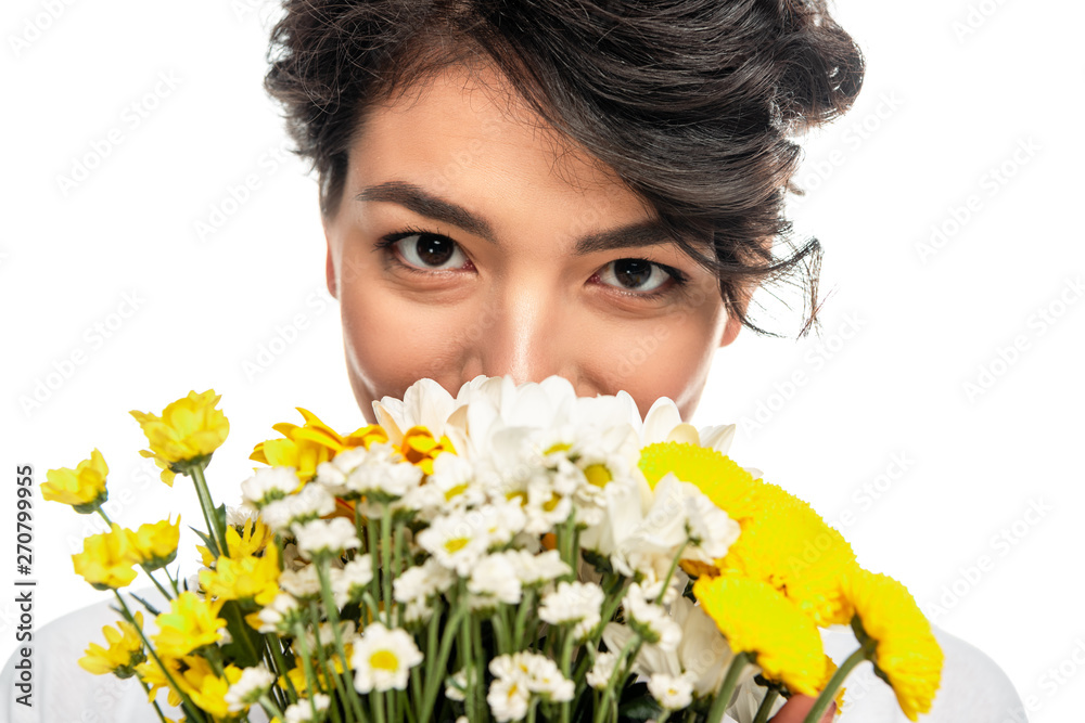 latin woman covering face while smelling flowers isolated on white latin woman covering face while smelling flowers isolated on white