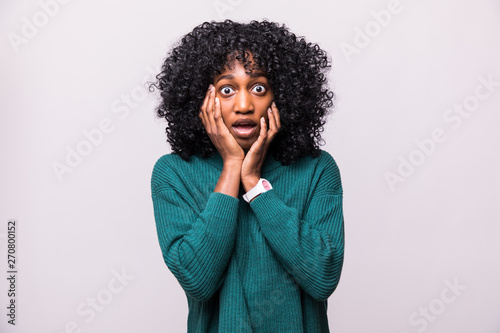 Portrait of beautiful scared young african woman female with curly hairstyle shocked isolated on white background photo
