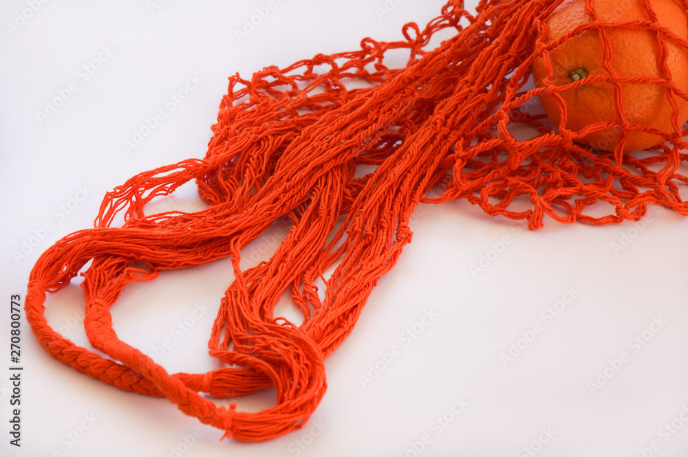 Handmade cotton reusable Orange string bag white background Handmade cotton reusable Orange string bag white background