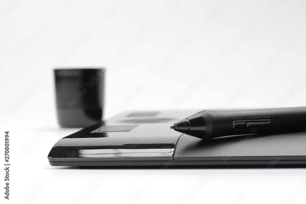 A close-up of pen on graphic tablet on white background A close-up of pen on graphic tablet on white background