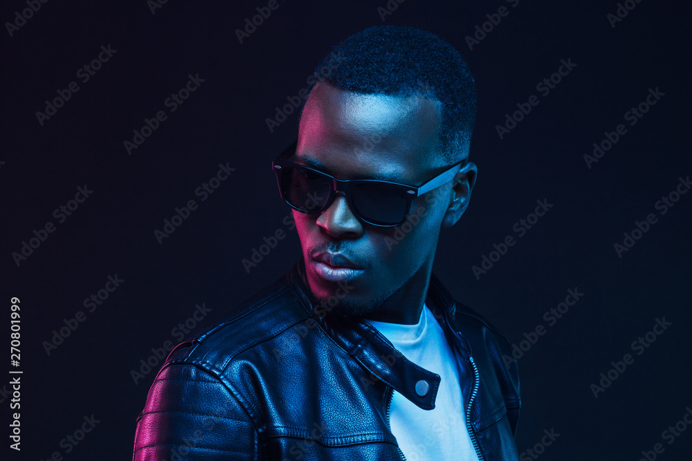 Close-up portrait of stylish black young man, wearing leather jacket and sunglasses