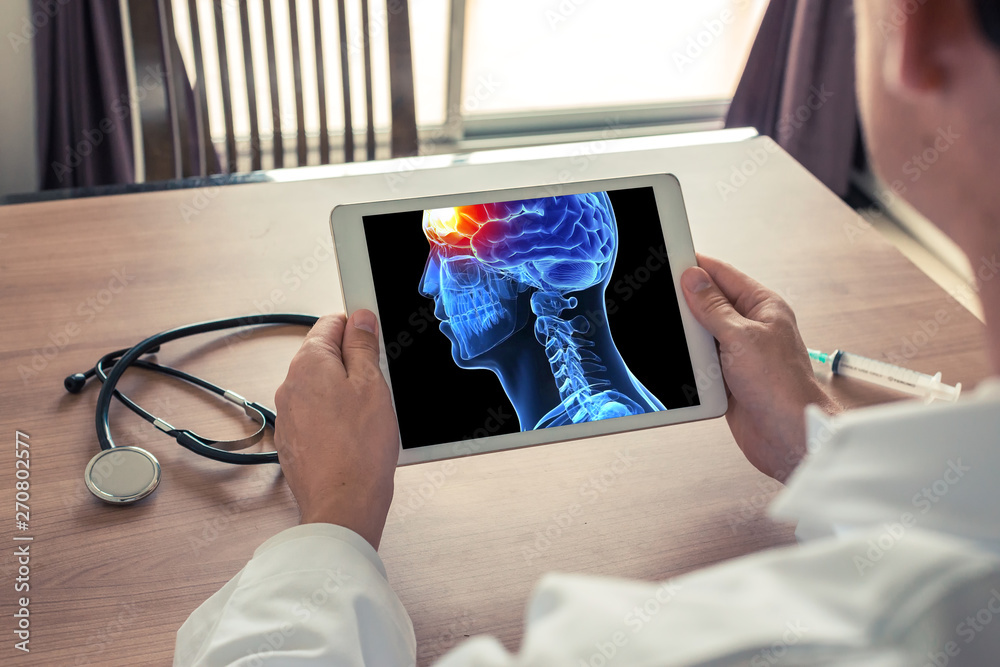 Fototapeta premium Doctor holding a digital tablet with x-ray of 3D head and pain in the front of brain. Migraine and headache concept