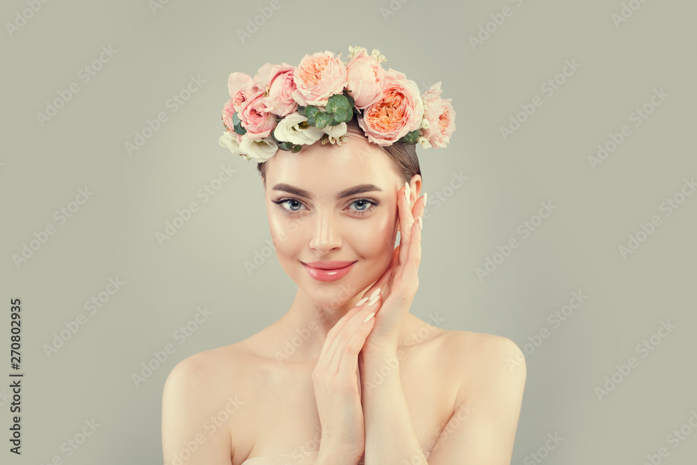 Healthy woman smiling. Spa beauty. Pretty woman with clear skin and flowers. Skincare and facial treatment concept