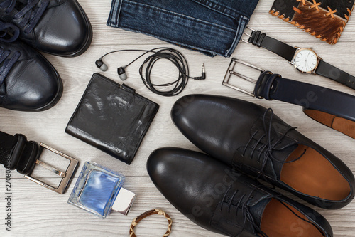 Two pairs of black leather men's shoes, belts for men, jeans and accessories.
