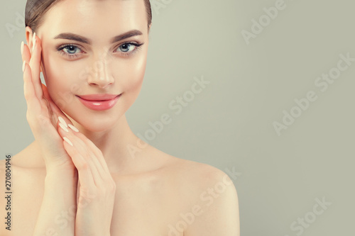 Closeup portrait of beautiful woman face. Healthy model with clear skin smiling