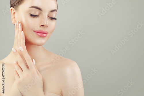 Healthy woman spa model with clear skin on gray background