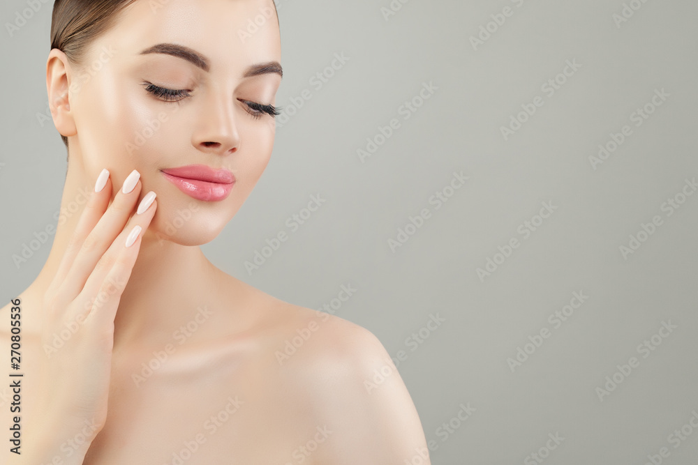 Young beautiful woman spa model with clear skin on gray background Young beautiful woman spa model with clear skin on gray background
