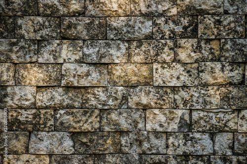 A background image consisting of aged and weathered grungy bricks with spots of sunlight on them.