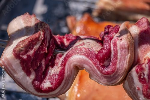 Traditional sardinian pancetta (Pork Lard, Bacon) in an open grill in Sassari, Sardinia, Italy photo