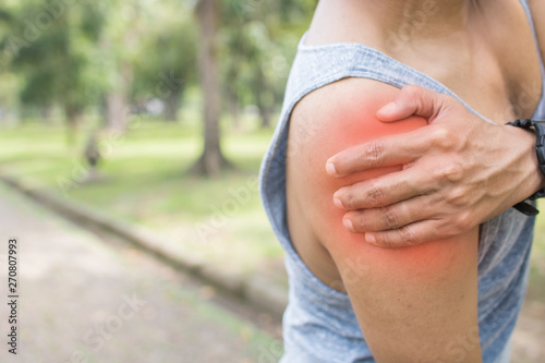 sport man has shoulder pain or injured and workout as exercise in park