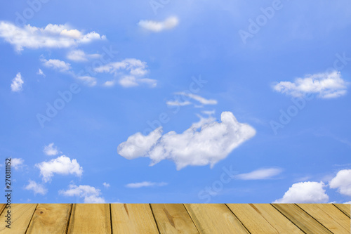 Plank, blue sky and clouds