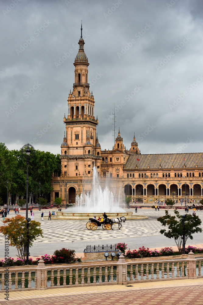 North tower and Vicente Traver fountain with horse and carriage at Plaza de Espana Seville