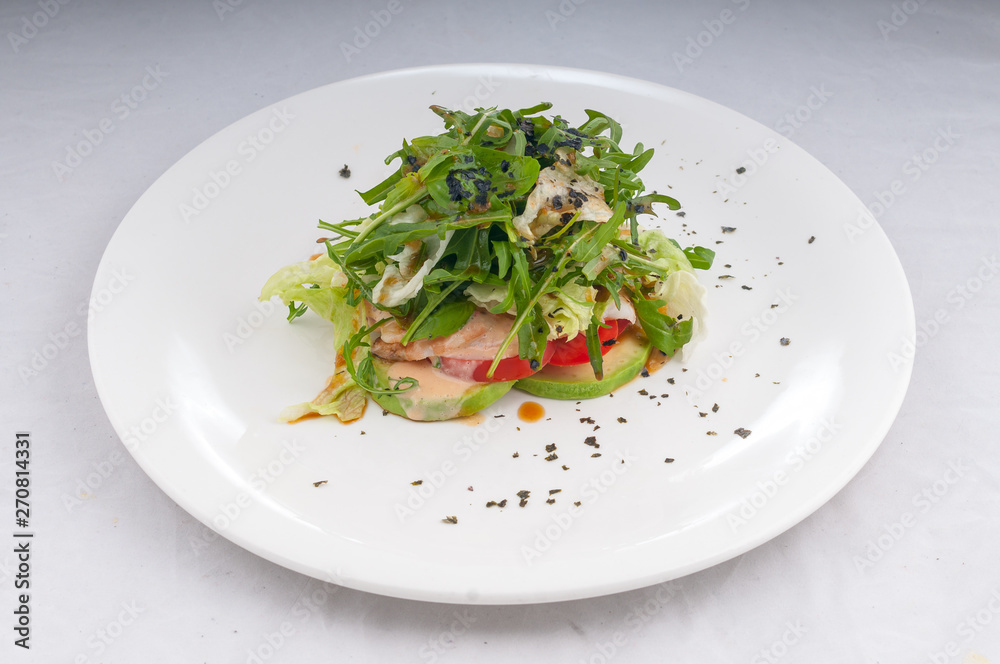 salad with rucola and vegetables zucchini tomatoes on a white plate on a clean white background salad with rucola and vegetables zucchini tomatoes on a white plate on a clean white background