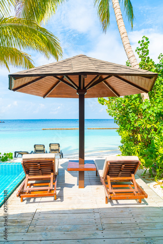 beach chair with swimming pool and sea background in Maldives