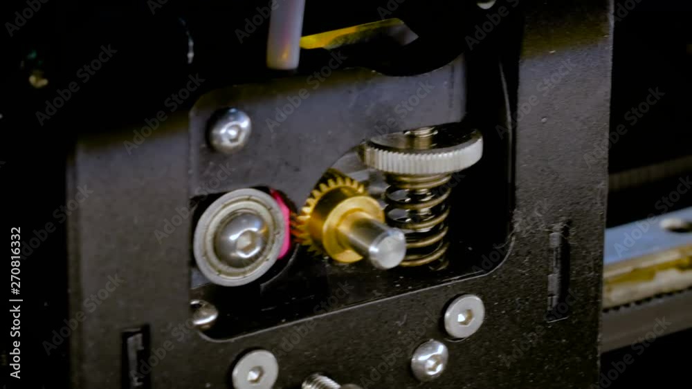 Print head of 3D printer machine printing plastic model at modern scifi technology exhibition - close up shot. 3D printing, additive technologies, 4.0 industrial revolution and futuristic concept