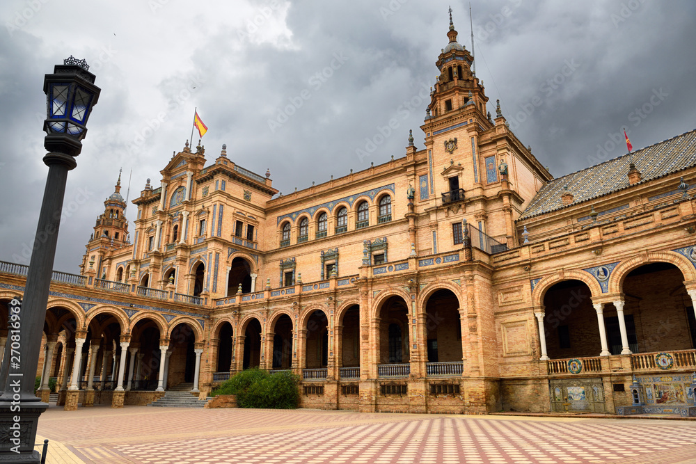 Empty square and dark clouds at the Main Building of Plaza de Espana Seville Spain