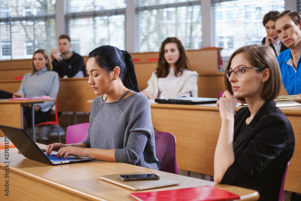 Multinational group of students in an auditorium Multinational group of students in an auditorium