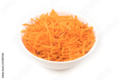 Fresh Grated carrot into a white bowl