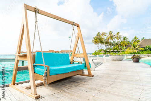 sofa swing with tropical Maldives resort and sea background